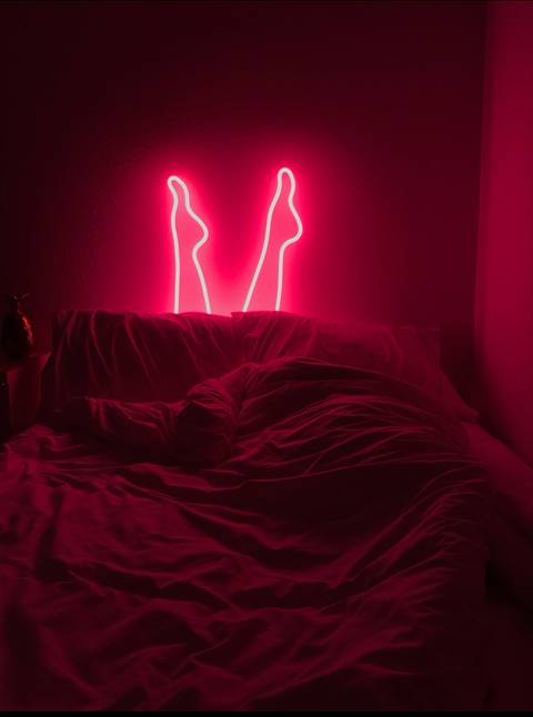 Glass Art Neon Pink Legs coming out of a bed and bed sheets