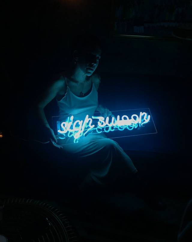 Sigh Swoon Holding a Custom Neon Sign made by Neon Flamingo